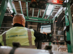Unilin Insulation factory worker driving a forklift